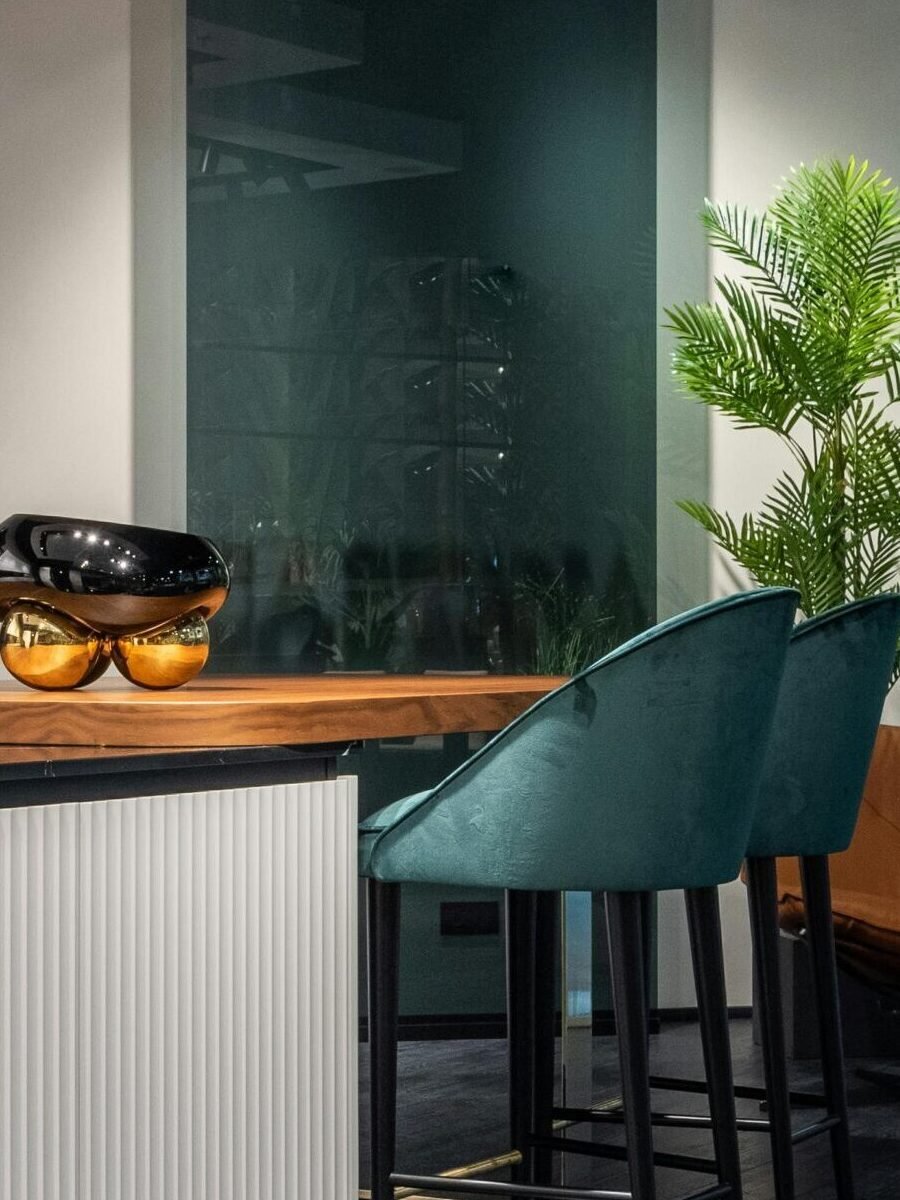 Elegant modern kitchen with sleek bar stools and contemporary decor.