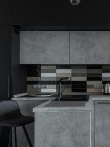 Sleek modern kitchen with black and gray cabinetry, perfect for minimalist decor.