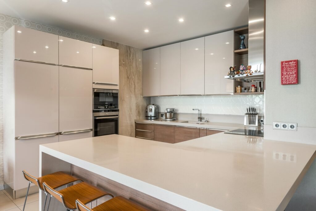 Contemporary kitchen featuring sleek cabinets, countertops, and modern appliances.